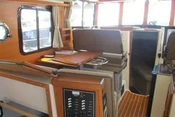  Yacht Photos Pics 2021 Ranger Tugs R-31 CB interior with seating, table, and wood accents.