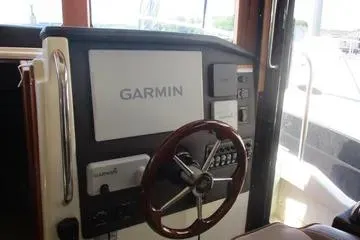  Yacht Photos Pics 2021 Ranger Tugs R-31 CB helm with Garmin navigation system and wooden steering wheel.