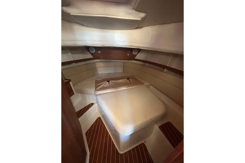  Yacht Photos Pics 2021 Ranger Tugs R-31 CB cabin interior with cozy bed and wooden accents.