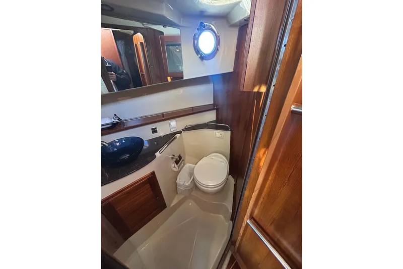  Yacht Photos Pics 2021 Ranger Tugs R-31 CB bathroom with modern fixtures and wooden accents.