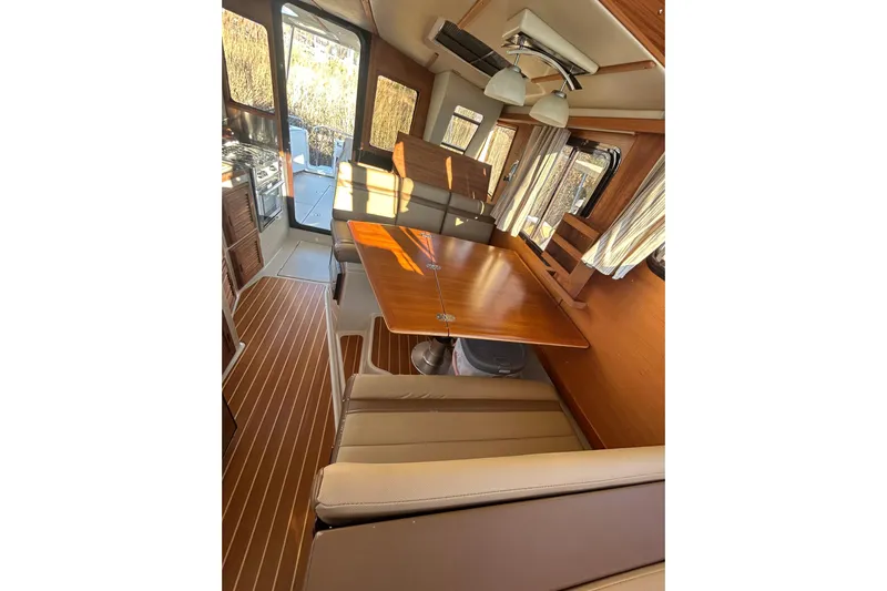  Yacht Photos Pics Interior of 2021 Ranger Tugs R-31 CB with wood accents and seating area.