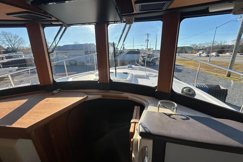 Yacht Photos Pics Interior view of 2021 Ranger Tugs R-31 CB boat, showcasing helm and windows.