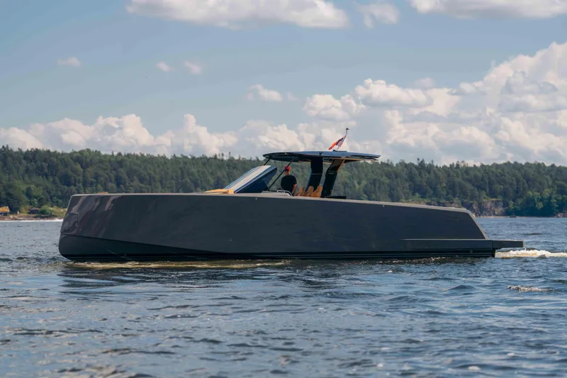 Delilah Yacht Photos Pics 2024 Pardo Yachts 43 cruising on a scenic lake under a partly cloudy sky.