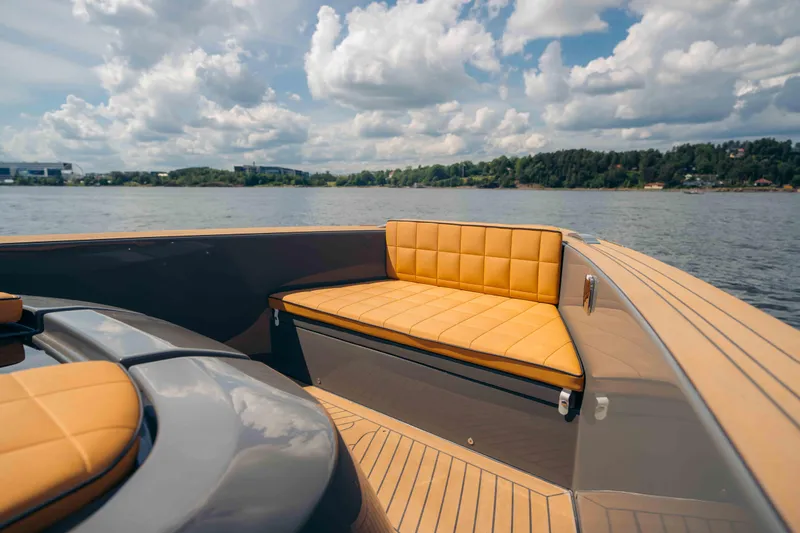 Delilah Yacht Photos Pics 2024 Pardo Yachts 43 with luxurious seating, cruising on a serene lake under a cloudy sky.