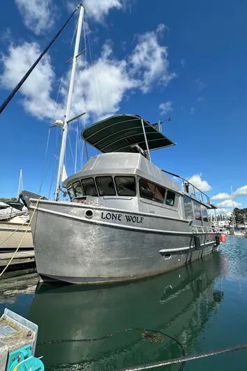 Lone Wolf Yacht Photos Pics Custom 2002 Carlson Marine Trawler "Lone Wolf" docked under clear blue sky.