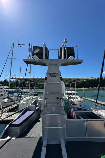 Lone Wolf Yacht Photos Pics Custom 2002 Carlson Marine Trawler docked under clear blue sky.