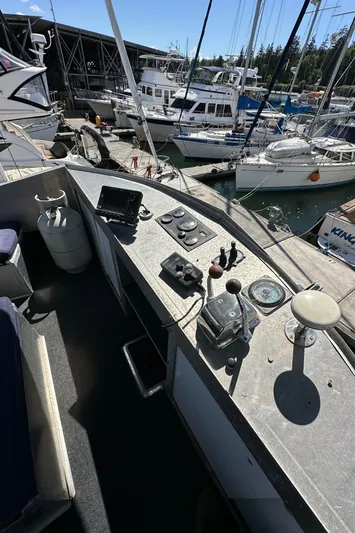 Lone Wolf Yacht Photos Pics Cockpit of 2002 Carlson Marine Trawler with navigation controls, docked at marina.