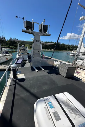 Lone Wolf Yacht Photos Pics 2002 Carlson Marine Trawler on water, sunny day, docked with other boats.