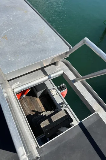 Lone Wolf Yacht Photos Pics Custom Carlson Marine Trawler 2002, metal deck and railing, overlooking water.