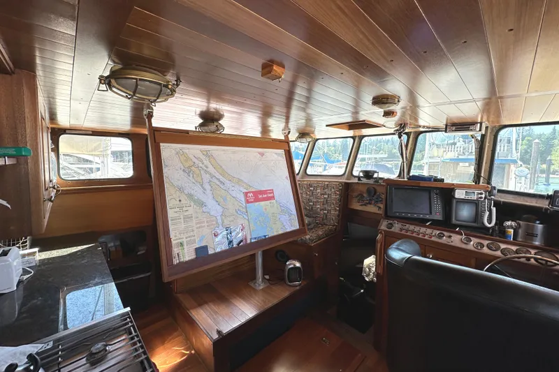Lone Wolf Yacht Photos Pics Pilothouse of 2002 Carlson Marine Trawler with navigation map and control panel.