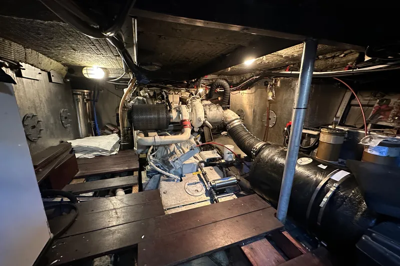 Lone Wolf Yacht Photos Pics Engine room of a 2002 Carlson Marine Trawler, showcasing mechanical components and piping.