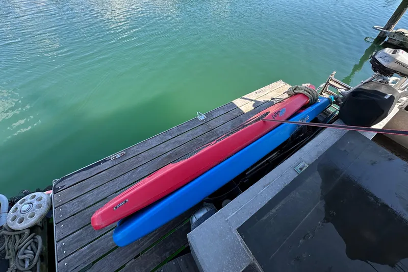Lone Wolf Yacht Photos Pics Dockside view with red and blue kayaks beside a 2002 Carlson Marine Trawler.