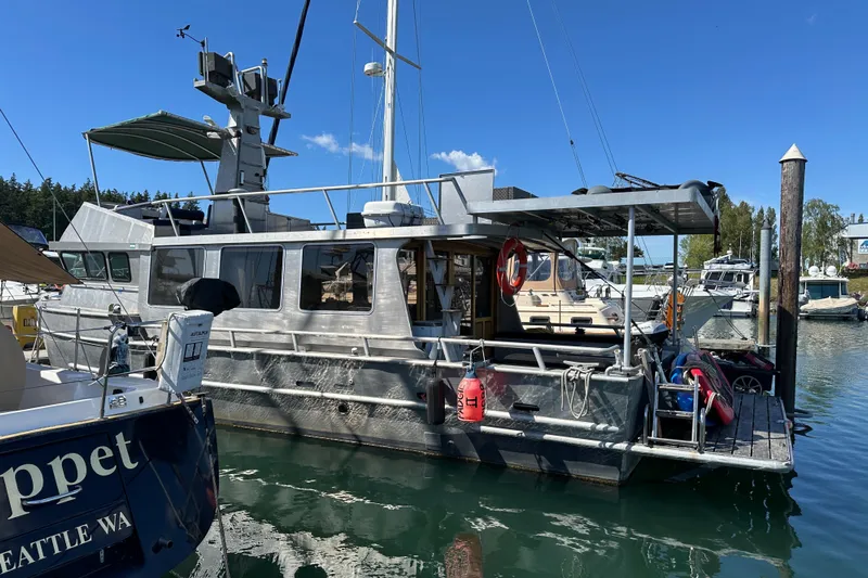 Lone Wolf Yacht Photos Pics Custom 2002 Carlson Marine Trawler docked at marina under clear blue sky.