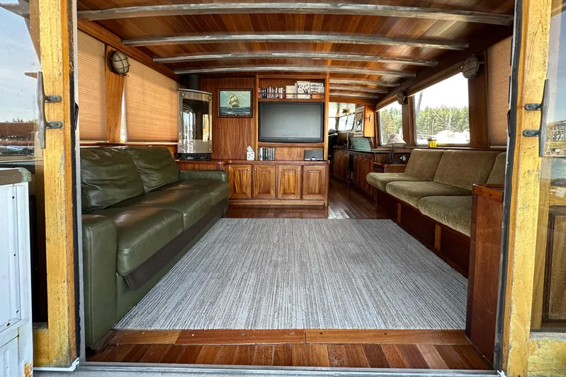 Lone Wolf Yacht Photos Pics Interior of 2002 Carlson Marine Trawler with wooden decor and comfortable seating.