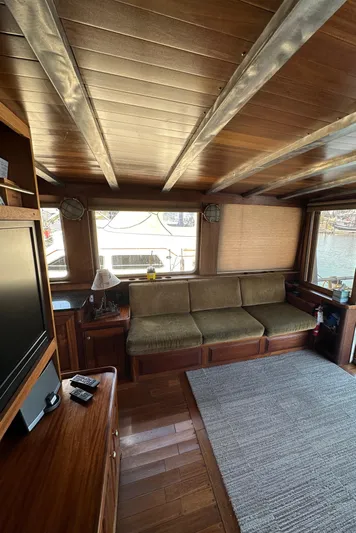 Lone Wolf Yacht Photos Pics Interior of 2002 Carlson Marine Trawler with wooden decor and comfortable seating.