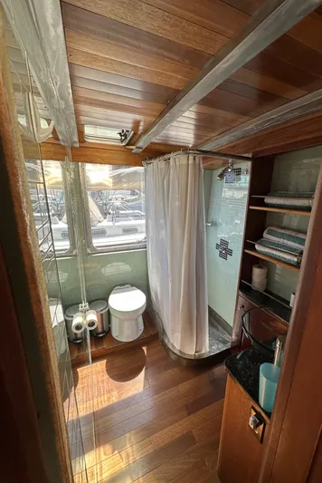 Lone Wolf Yacht Photos Pics Bathroom interior of 2002 Carlson Marine Trawler with wood accents and modern amenities.