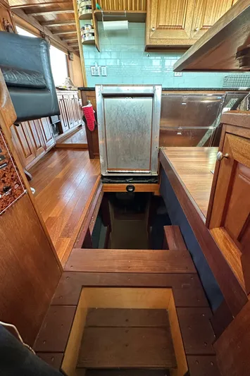 Lone Wolf Yacht Photos Pics Interior of 2002 Carlson Marine Trawler with wooden cabinetry and stairs.