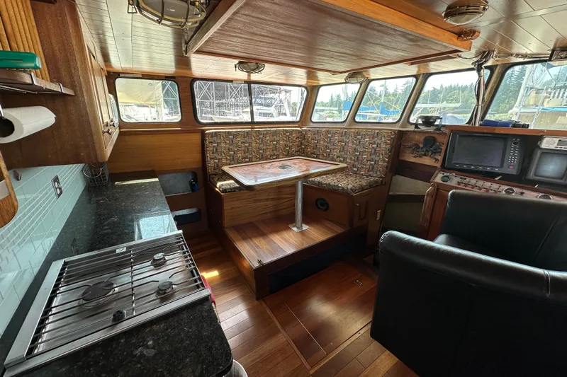 Lone Wolf Yacht Photos Pics Interior of 2002 Carlson Marine Trawler with kitchen, seating, and navigation equipment.