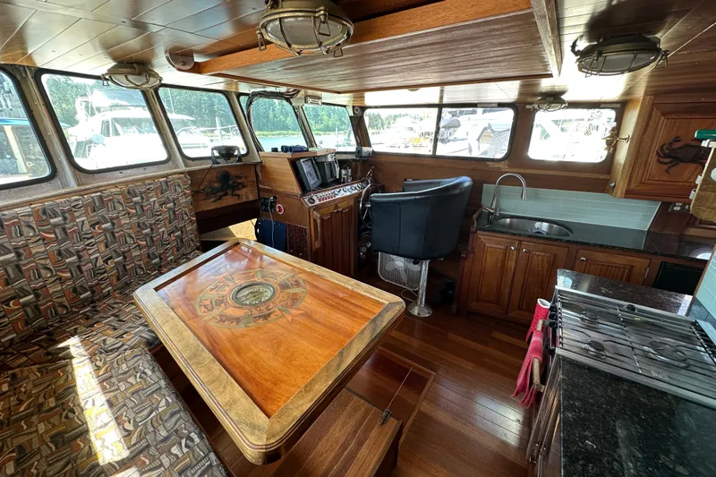 Lone Wolf Yacht Photos Pics Interior of 2002 Carlson Marine Trawler with wood finish, seating, and navigation area.