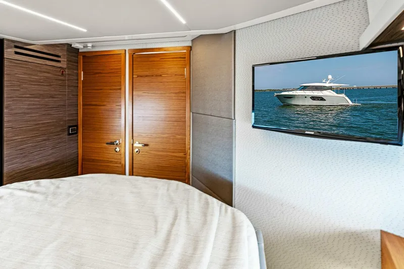 Victory Yacht Photos Pics 2019 Tiara Yachts 49 COUPE interior bedroom with TV and wooden doors.