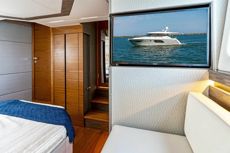Victory Yacht Photos Pics Interior of 2019 Tiara Yachts 49 COUPE with TV displaying yacht on water.