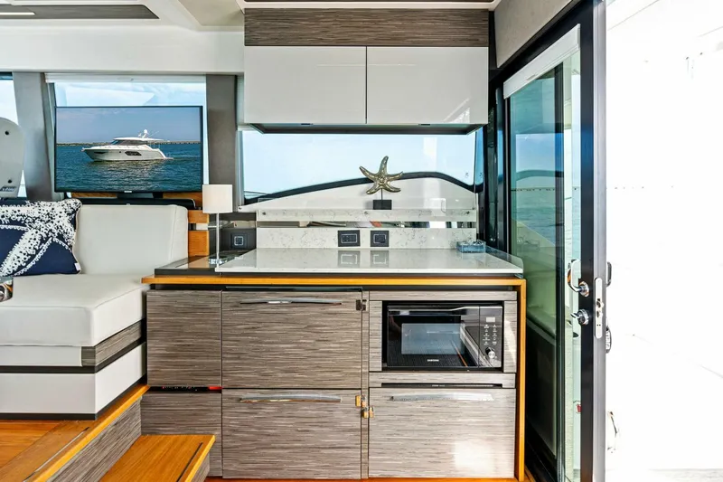 Victory Yacht Photos Pics Modern interior of 2019 Tiara Yachts 49 COUPE with kitchenette and ocean view.