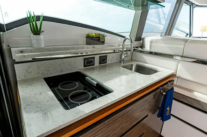 Victory Yacht Photos Pics Modern kitchen area in 2019 Tiara Yachts 49 COUPE with sleek countertops and built-in appliances.