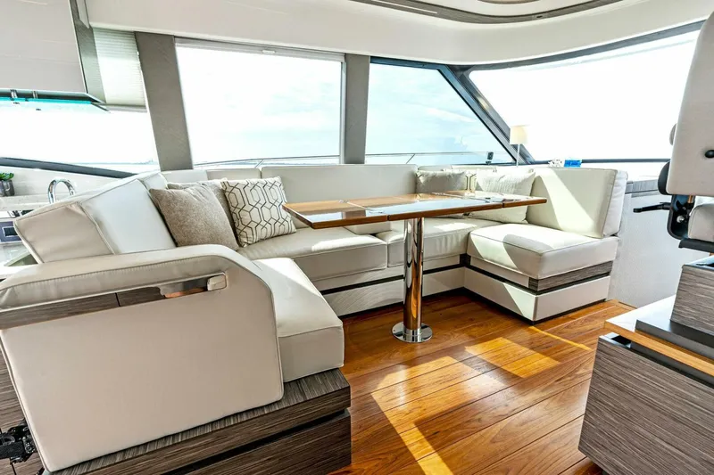 Victory Yacht Photos Pics Luxurious interior of 2019 Tiara Yachts 49 COUPE with elegant seating and wooden flooring.