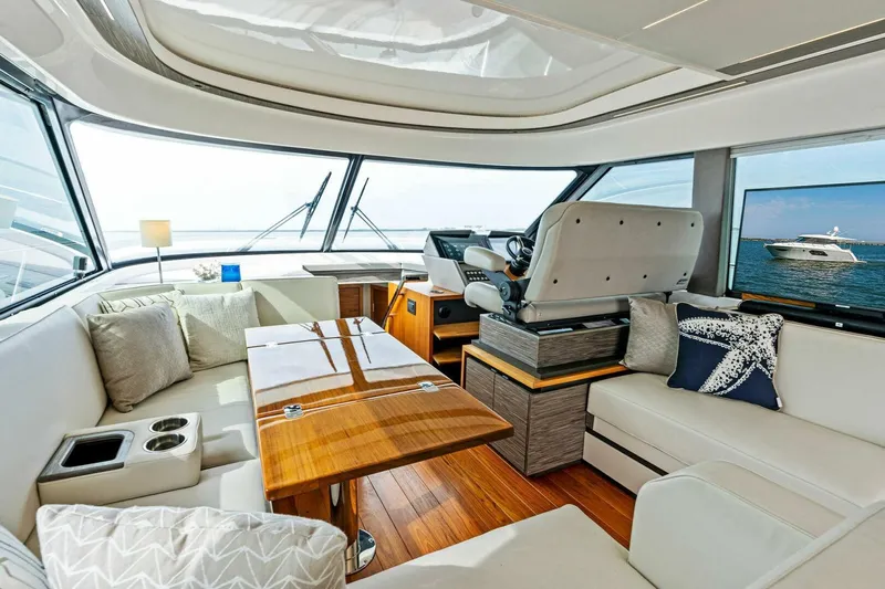 Victory Yacht Photos Pics Luxurious interior of 2019 Tiara Yachts 49 COUPE with modern furnishings and panoramic windows.