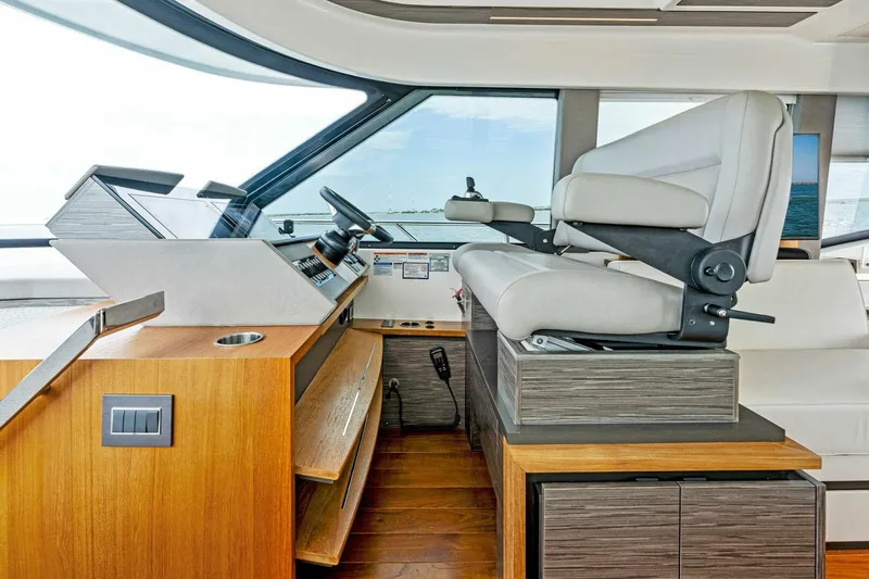 Victory Yacht Photos Pics Interior helm station of 2019 Tiara Yachts 49 COUPE with modern controls and seating.