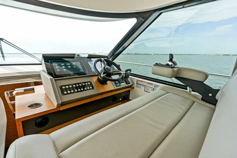 Victory Yacht Photos Pics 2019 Tiara Yachts 49 COUPE helm station with modern controls and panoramic view.