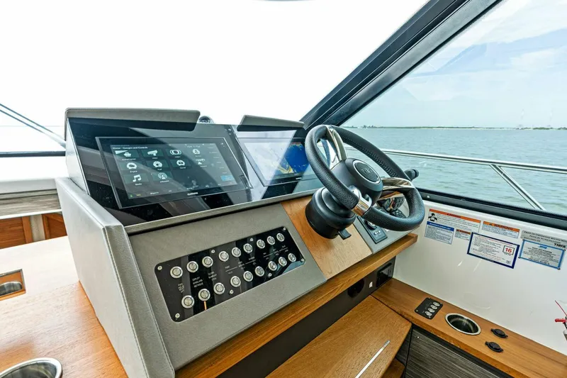 Victory Yacht Photos Pics 2019 Tiara Yachts 49 COUPE helm station with touchscreen controls and steering wheel.