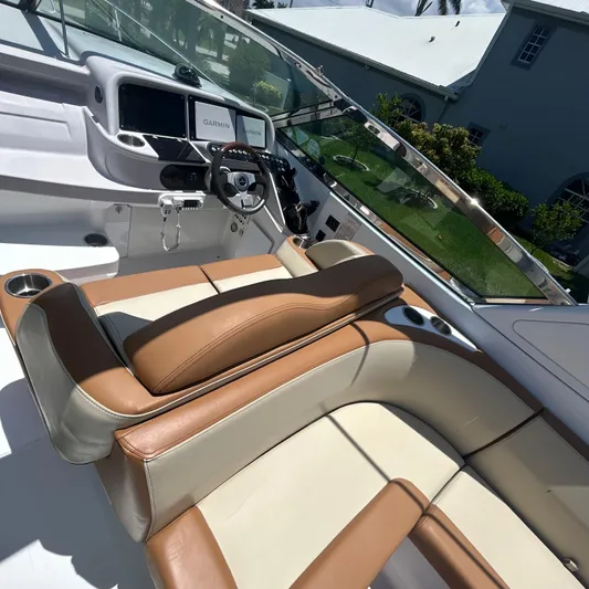  Yacht Photos Pics 2005 Formula 330 SS boat interior with tan and cream seating, steering wheel, and navigation screens.