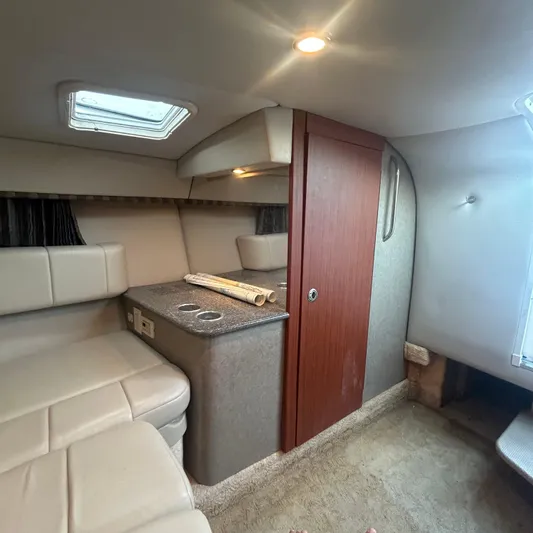  Yacht Photos Pics Interior of 2005 Formula 330 SS boat, featuring seating, wood paneling, and overhead lighting.