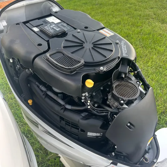  Yacht Photos Pics Engine of a 2005 Formula 330 SS boat, detailed view, on grass background.