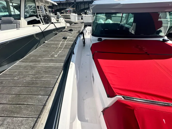 Rachel's Glory Yacht Photos Pics 2022 Axopar 37 XC Cross Cabin BRABUS LINE docked, featuring a vibrant red cover.