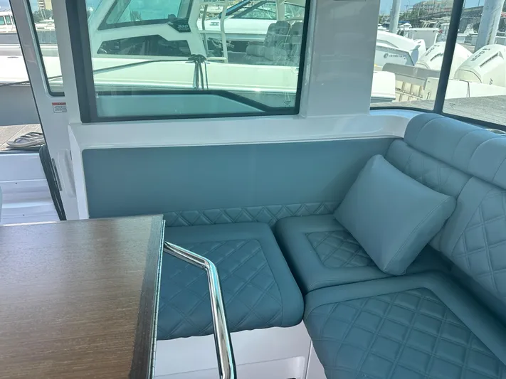 Rachel's Glory Yacht Photos Pics Interior seating of 2022 Axopar 37 XC Cross Cabin BRABUS LINE with blue cushions.