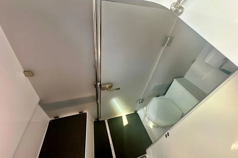 Rachel's Glory Yacht Photos Pics 2022 Axopar 37 XC CROSS CABIN bathroom interior with modern fixtures and compact design.