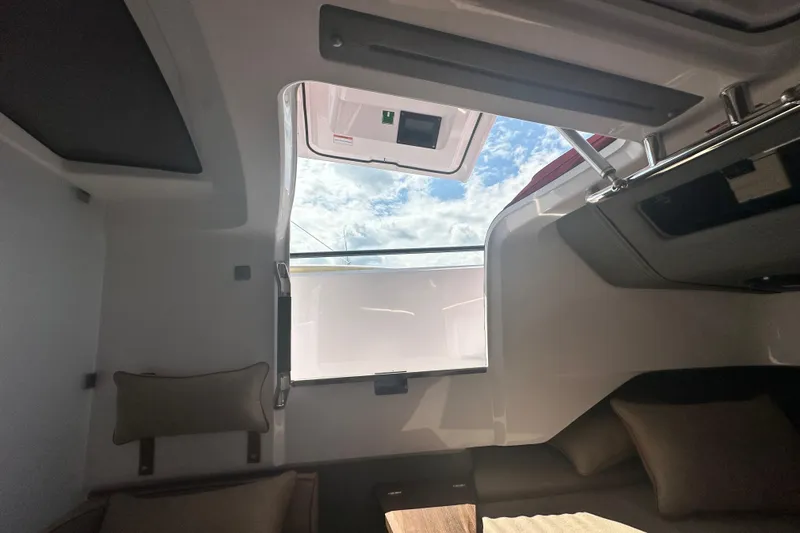 Rachel's Glory Yacht Photos Pics Interior view of 2022 Axopar 37 XC CROSS CABIN with open roof hatch and cushions.