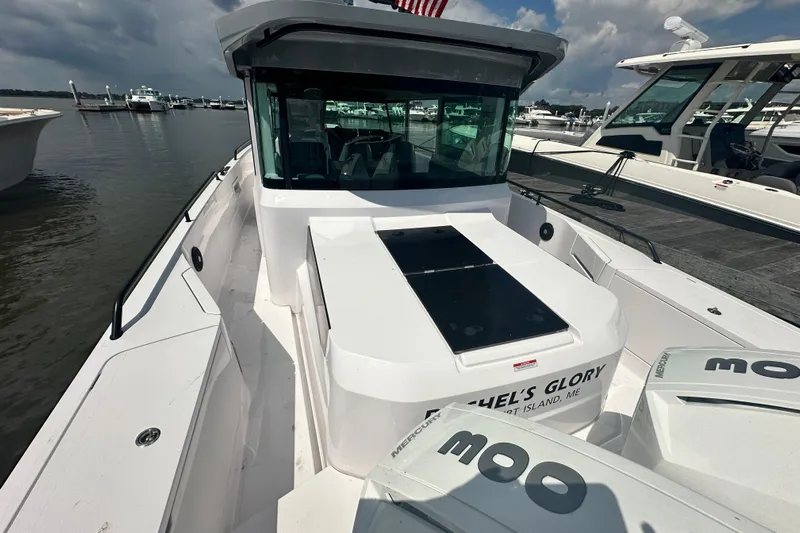 Rachel's Glory Yacht Photos Pics 2022 Axopar 37 XC CROSS CABIN boat docked at marina, featuring sleek design and modern cabin.