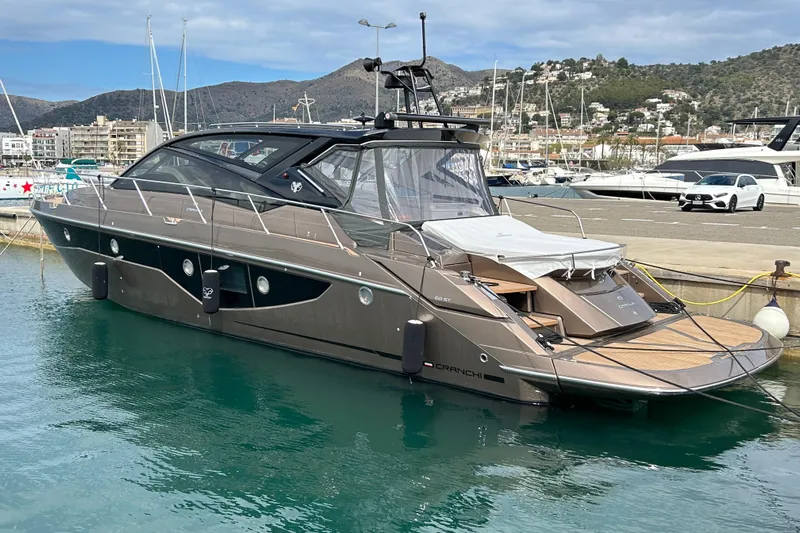  Yacht Photos Pics 2023 Cranchi 60 ST yacht docked in a marina, showcasing sleek design and luxury features.