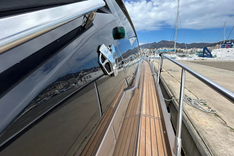  Yacht Photos Pics 2023 Cranchi 60 ST yacht docked, showcasing sleek design and wooden deck.