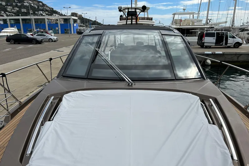  Yacht Photos Pics 2023 Cranchi 60 ST yacht docked at marina, showcasing sleek design and spacious deck.