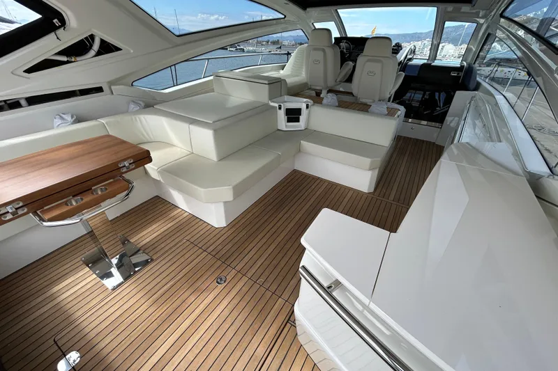  Yacht Photos Pics Luxurious interior of 2023 Cranchi 60 ST yacht with elegant seating and wooden flooring.