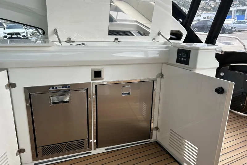  Yacht Photos Pics 2023 Cranchi 60 ST yacht interior with stainless steel appliances and sleek cabinetry.