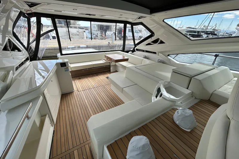  Yacht Photos Pics Luxurious interior of 2023 Cranchi 60 ST yacht with elegant seating and wooden flooring.