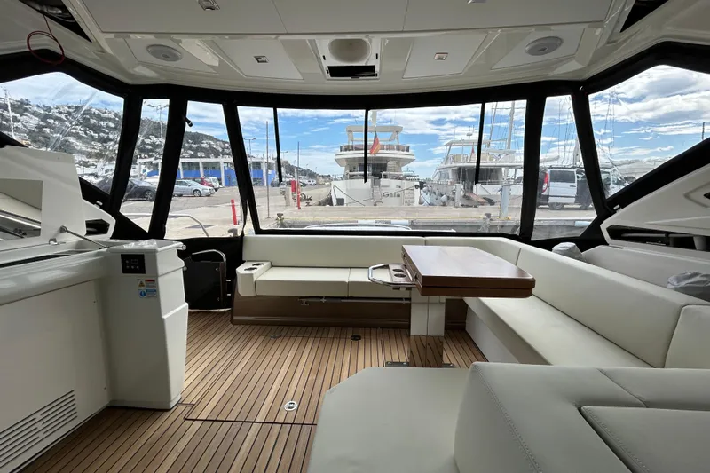  Yacht Photos Pics Luxurious interior of 2023 Cranchi 60 ST yacht with panoramic windows and elegant seating.