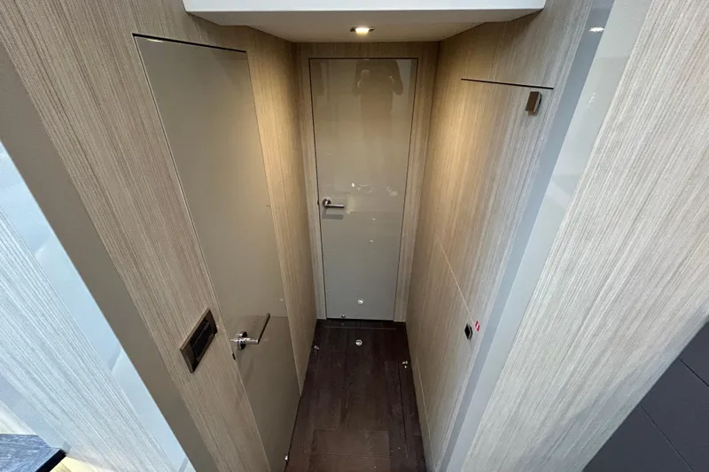  Yacht Photos Pics Modern interior hallway of 2023 Cranchi 60 ST yacht with sleek wooden paneling.