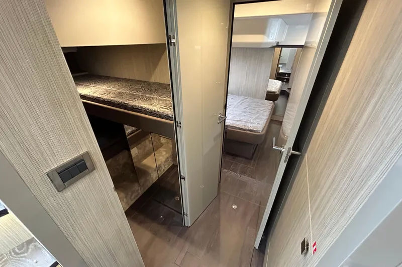  Yacht Photos Pics Interior of 2023 Cranchi 60 ST yacht, featuring modern cabin with bunk beds and sleek design.