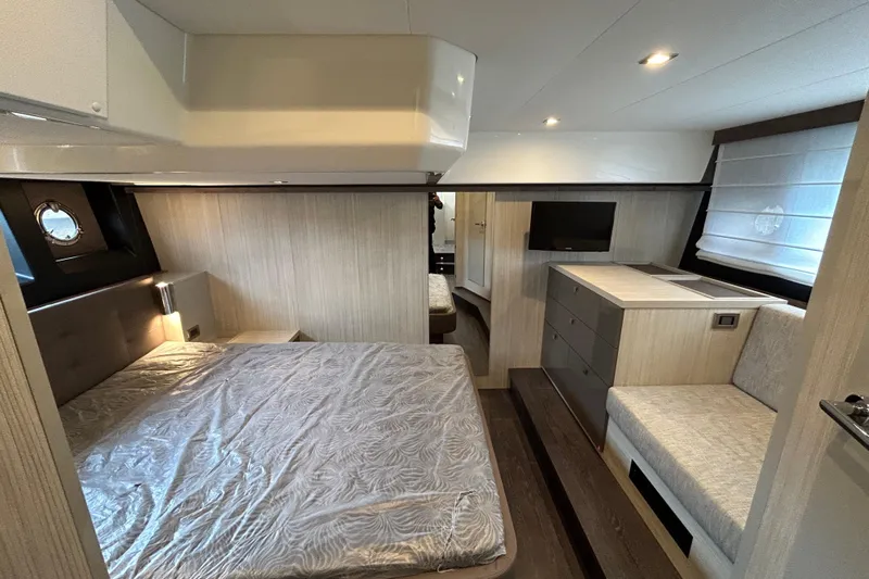  Yacht Photos Pics Luxurious interior of 2023 Cranchi 60 ST yacht with modern bedroom and seating area.